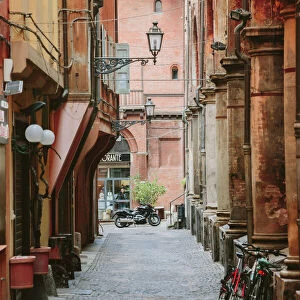 Narrow street in the old town of Bologna, Emilia-Romagna, Italy