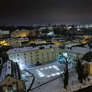Neumunster Abbey in Luxembourg at night under snow