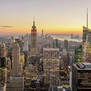 New York City skyline with illuminated skyscrapers seen from above during sunrise, New York State, USA