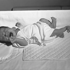 Newborn (0-3 months) lying in crib, crying, (B&W)