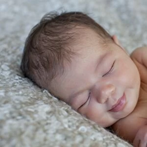 Newborn baby, five days, asleep, smiling