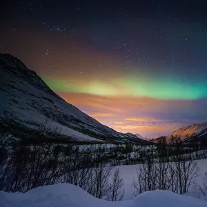 Northern lights in snow valley