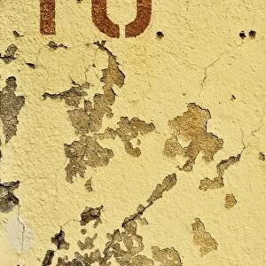 The number ten on crumbling plaster