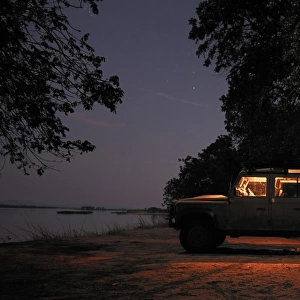 Off-road car and evening campsite alongside the Zambezi River, Mana Pools, Zambezi Valley, Zimbabwe