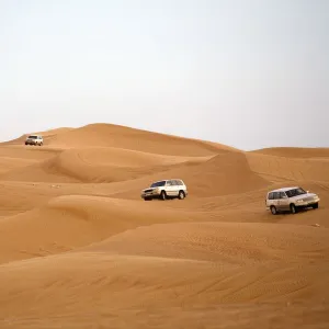 Off-road Vehicles Navigating Down a Sand Dune. Hatta, United Arab Emirates