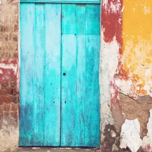 Old and beautiful turquoise door and old multicorored facade at house Old and beautiful turquoise door and old multicorored facade at house