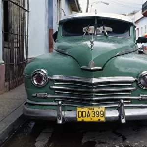 Old blue car parked in street, Havana, Cuba