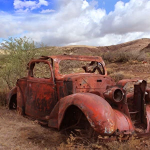 Old car rusting in Desert Landscape