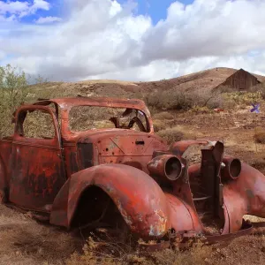 Old Car Rusting Print in Desert Landscape with Barn Old Car Rusting Print in Desert Landscape with Barn