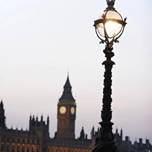 Old-Fashioned Street Lamp With Houses Of Parliament Illuminated In The Background, London, England