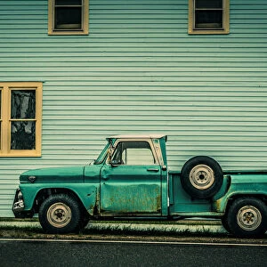 Old Green Truck against Green Building