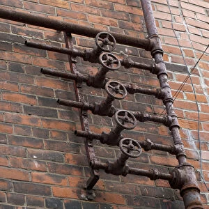 Old pipes on brick wall, Montreal, Quebec, Canada