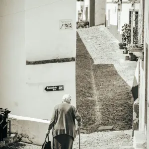 Old woman walks in the road Old woman walks in the road