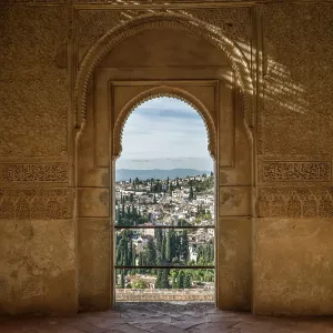 Ornate detail on an interior wall facade with a view of the town of Granada
