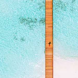 Overhead view of woman walking on jetty, Maldives
