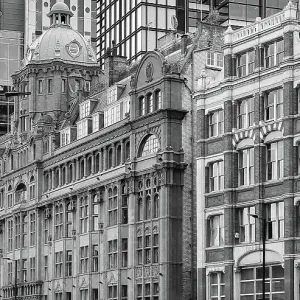 Overlapping facades of old and new office buildings in London, England