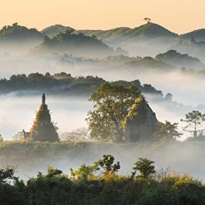 Pagodas and temples in the mist in Mrauk U, Myanmar. In the Morning time