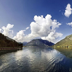 Panorama of Lake Achensee with the Rofan Mountains and bizarre clouds in the sky reflecting in the lake, Achensee, Tyrol, Austria, Europe