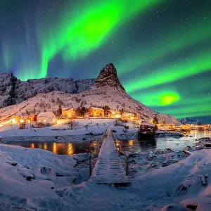 Panorama of Reine's wooden bridge with Aurora and Reine mountian in the background -stock photo Panorama of Reine's wooden bridge with Aurora and Reine mountian in the background -stock photo