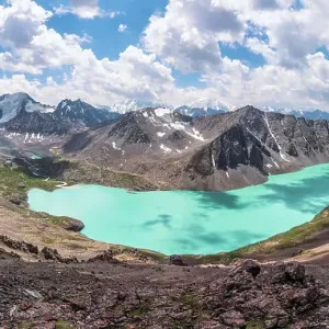 The panoramic view of Ala-Kul lake on high altitude Tien Shan mountains, near Karakol, Kyrgyzstan The panoramic view of Ala-Kul lake on high altitude Tien Shan mountains, near Karakol, Kyrgyzstan