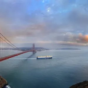 Panoramic view of the Golden Gate Bridge at sunset with a rainbow and storm clouds, San Francisco, California, United States Panoramic view of the Golden Gate Bridge at sunset with a rainbow and storm clouds, San Francisco, California, United States