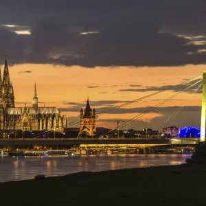 Panoramic view of the Rhine with Cologne Cathedral, Severinsbrucke Bridge, the Musical Dome and Great St. Martin Church, at dusk, Cologne, North Rhine-Westphalia, Germany Panoramic view of the Rhine with Cologne Cathedral, Severinsbrucke Bridge, the Musical Dome and Great St. Martin Church, at dusk, Cologne, North Rhine-Westphalia, Germany