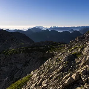 Peaks of the Allgau Alps in the early morning with a hiker, Oberstdorf, Bavaria, Germany