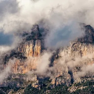 The Peña mountains to the north of Ainsa, Spain partially covered in clouds during dusk The Peña mountains to the north of Ainsa, Spain partially covered in clouds during dusk