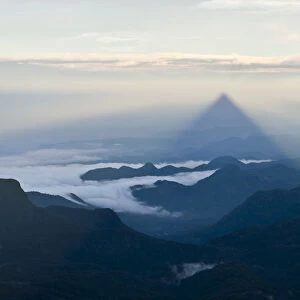 Pilgrim mountain, sun creating a triangle shadow in the landscape, image of God, Buddhist temple, Adams Peak, Sri Pada, Dalhousie, Zentrales Hochland, Sri Lanka