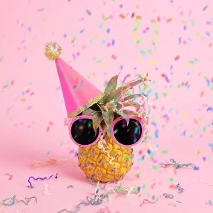 Pineapple with party hat and confetti