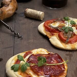 Pizzette, small pizzas with buffalo mozzarella, chorizo and coriander, front, and tomatoes and anchovies, rear