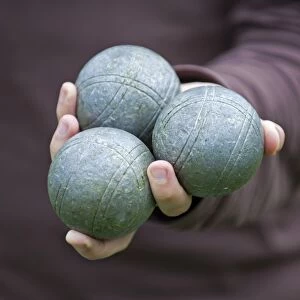 Player holding Boules or Petanque balls in his hand, Colmar, France, Europe