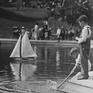 1929 Print of Two Boys Playing with a Model Boat in Central Park Lake 1929 Print of Two Boys Playing with a Model Boat in Central Park Lake