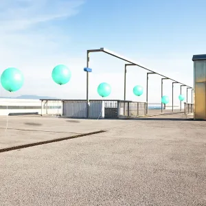 Poetic picture of stop motion pictures in one of a line of green balloons flying in city corner with nice perspective Poetic picture of stop motion pictures in one of a line of green balloons flying in city corner with nice perspective