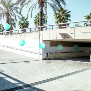 Poetic stop motion picture of green balloons following each other going out from tunnel in a minimal and cool underground pass in the city Poetic stop motion picture of green balloons following each other going out from tunnel in a minimal and cool underground pass in the city