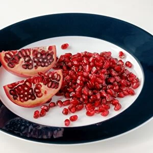 Pomegranate pieces and seeds on a plate