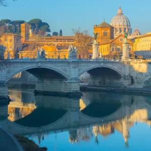 Ponte Vittorio Emmanual II over the Tiber river in Rome, in the background the dome of St. Peter Basilica