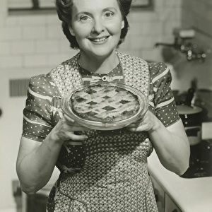 Portrait of mature woman holding pie