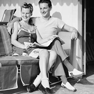 Portrait of young couple sitting outdoors