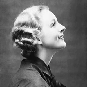 Profile of smiling woman, (B&W), close-up, portrait