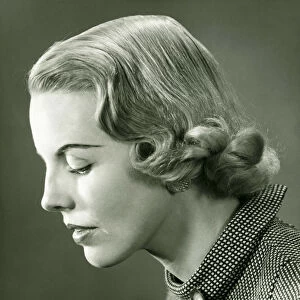 Profile of woman posing in studio, (B&W), portrait