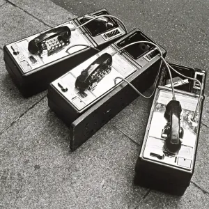 Public phones lying on sidewalk Public phones lying on sidewalk