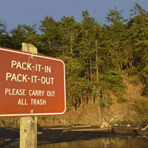 Rad sign informing to take all trash from park out, James Island, San Juan Islands, Washington State, USA