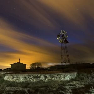 Raft of irrigation and windmill in the night