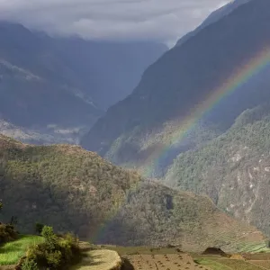 Rainbow Print over Rural Mountain Valley Landscape