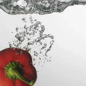 Red capsicum falling into water Red capsicum falling into water