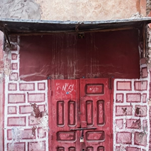 Red door in faux brick wall, Marrakech, Morocco
