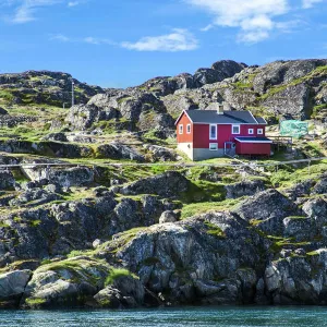 Red house on rocky coastline, Sisimiut, Greenland