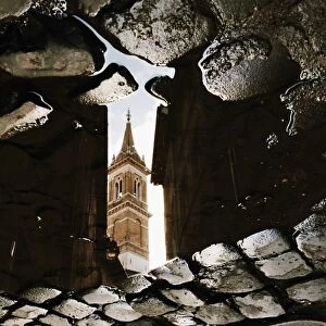 Reflection of the church in puddle, Rome, Italy
