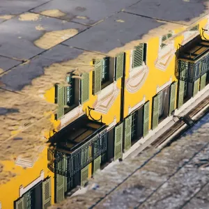 Reflection of a yellow building in a puddle, Nice, France Reflection of a yellow building in a puddle, Nice, France